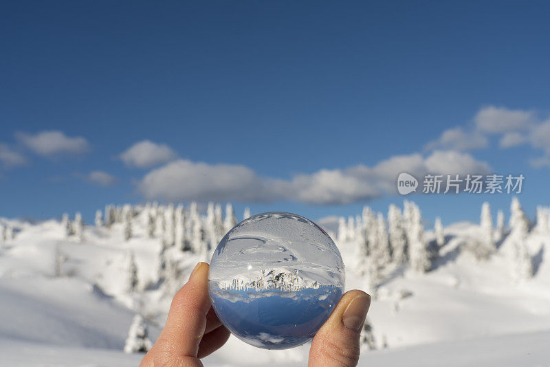 冰冻的冬季景观镜像在镜头球在Velika Planina对蓝色的天空